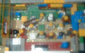 Blurred image of the mini figs carrying the chest